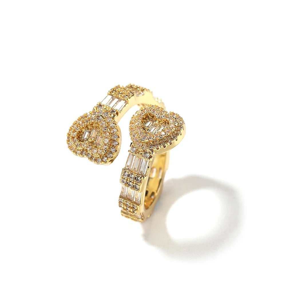 Gold heart ring with diamond accents on a white background