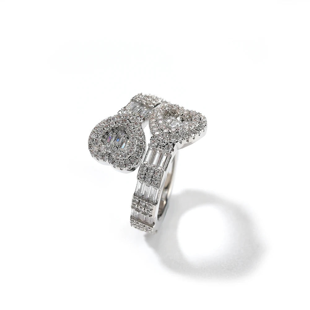 Silver heart baguette diamond ring with a white background